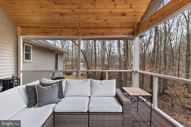 sunroom featuring vaulted ceiling and wood ceiling