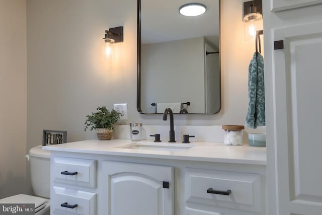 bathroom featuring toilet and vanity