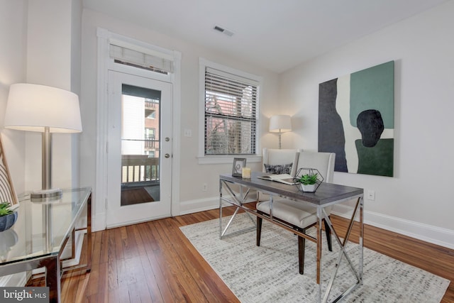 office with visible vents, baseboards, and hardwood / wood-style flooring