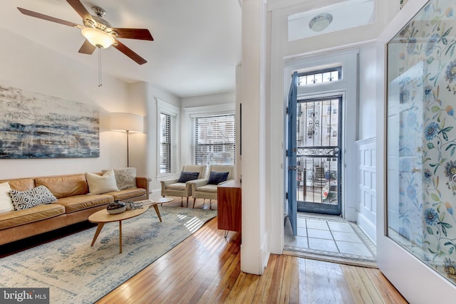 entrance foyer with light wood-style floors and a ceiling fan