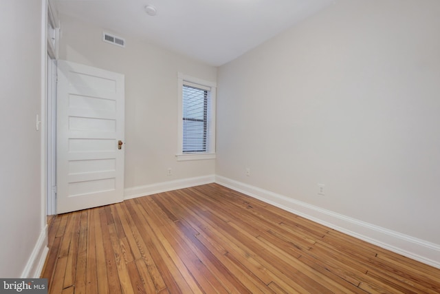 unfurnished room featuring visible vents, baseboards, and light wood finished floors