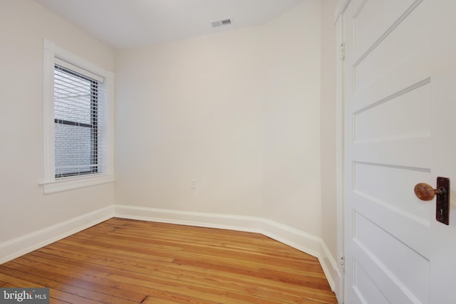 spare room with visible vents, baseboards, and light wood-style floors