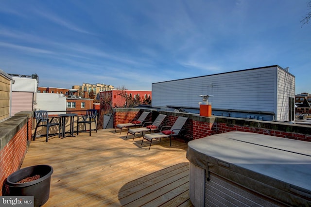 wooden deck featuring a hot tub