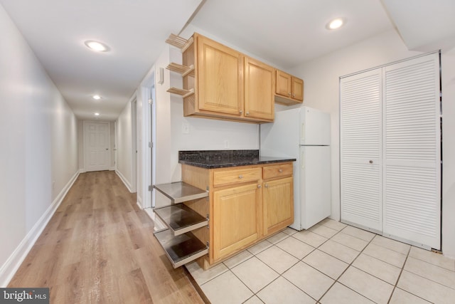 kitchen featuring light brown cabinetry, open shelves, freestanding refrigerator, recessed lighting, and baseboards