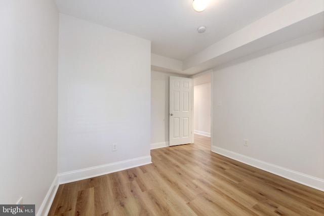 empty room featuring light wood-type flooring and baseboards