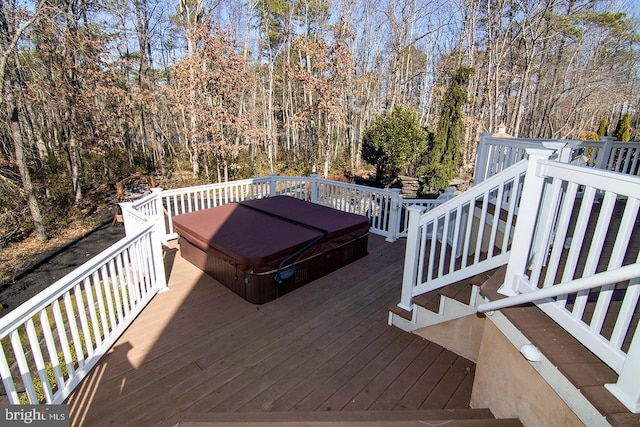 deck featuring a covered hot tub