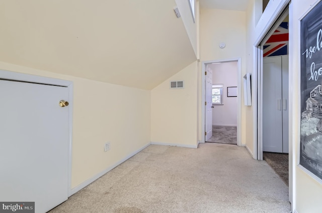 bonus room featuring visible vents, baseboards, light carpet, and lofted ceiling