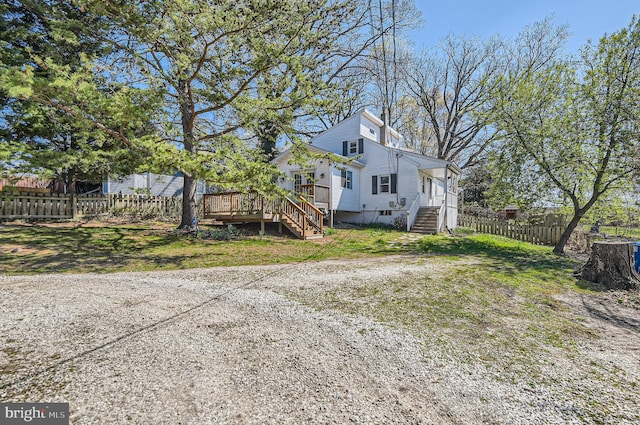 exterior space featuring a deck and fence