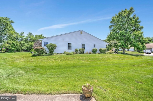 view of side of home with a lawn