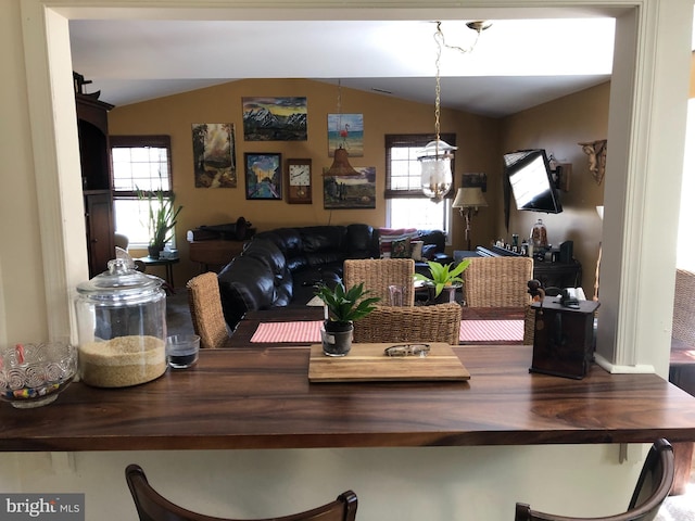 dining area with lofted ceiling and plenty of natural light