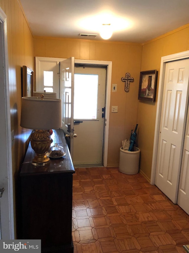 foyer entrance featuring visible vents