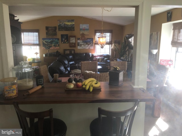 dining room with vaulted ceiling