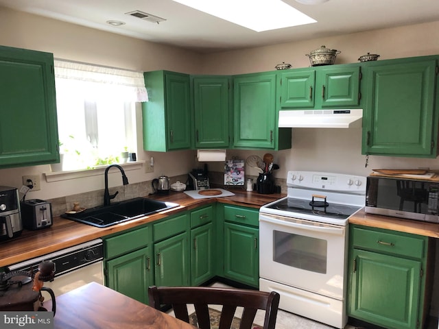 kitchen featuring visible vents, under cabinet range hood, a sink, white appliances, and a skylight