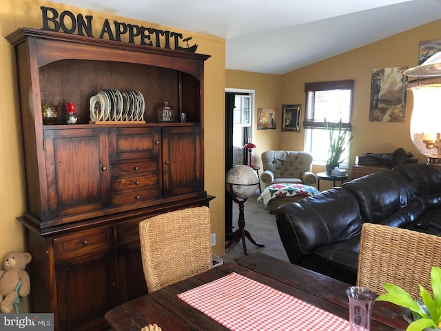 carpeted living room with lofted ceiling