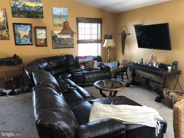 carpeted living room with vaulted ceiling