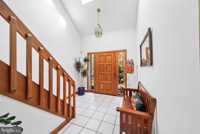 entrance foyer featuring stairway, high vaulted ceiling, and light tile patterned flooring