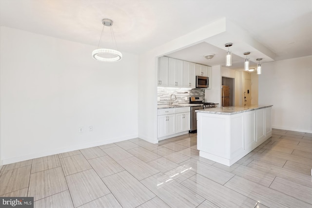 kitchen featuring a sink, stainless steel appliances, white cabinets, and decorative backsplash