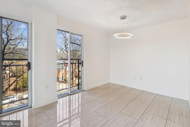 unfurnished room featuring baseboards