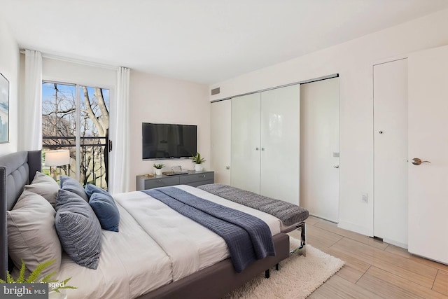 bedroom featuring visible vents and light wood-style floors