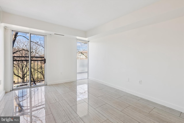 unfurnished room featuring visible vents and baseboards