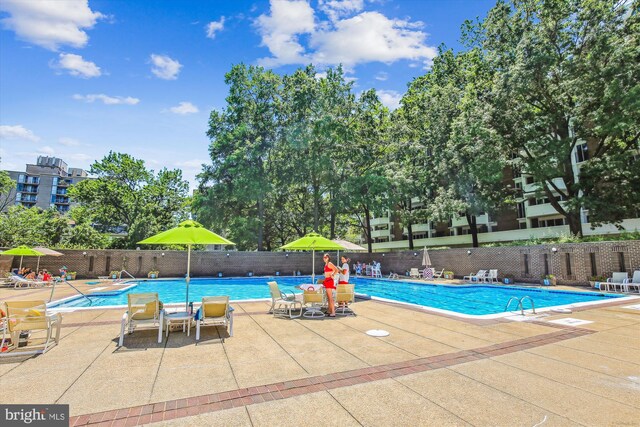 community pool featuring a patio and fence