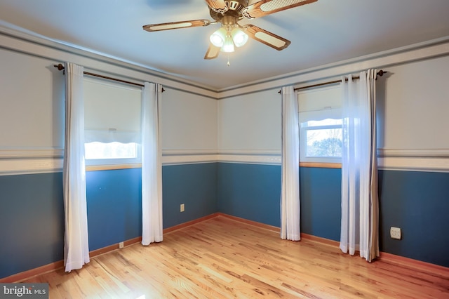 unfurnished bedroom featuring ceiling fan, light wood-type flooring, and baseboards