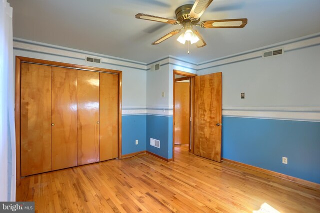 unfurnished bedroom with visible vents and wood finished floors