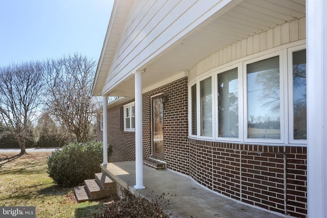 view of side of home with brick siding