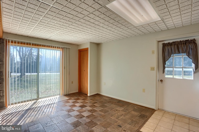 unfurnished room featuring baseboards