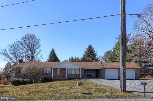 single story home featuring a front lawn, an attached garage, brick siding, and driveway