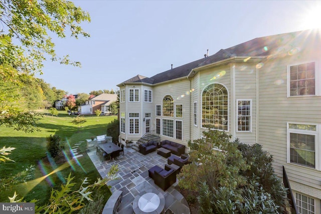 back of property featuring a patio area and a yard