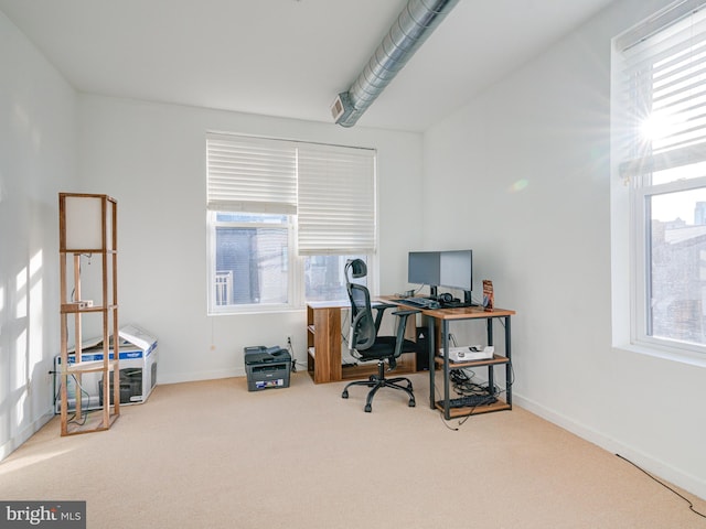 office area featuring baseboards and carpet floors