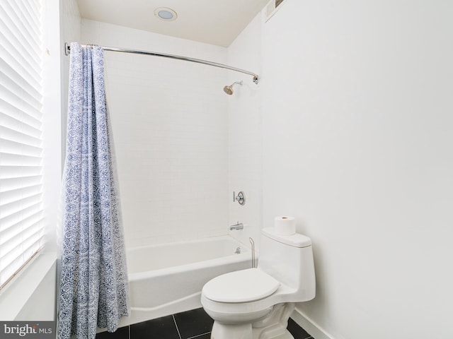 bathroom featuring tile patterned flooring, visible vents, baseboards, toilet, and shower / bath combo with shower curtain