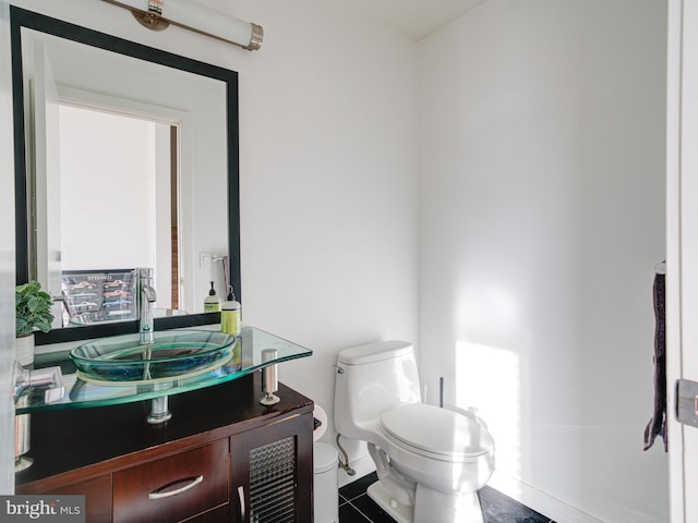 bathroom featuring toilet and vanity