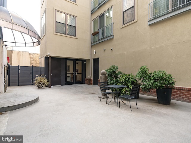 view of patio featuring french doors and fence