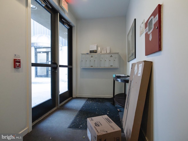 doorway featuring plenty of natural light and baseboards