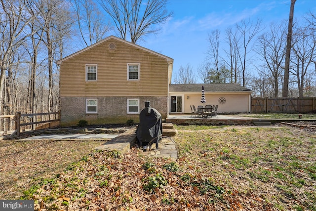 rear view of property with a patio area and fence