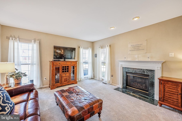 living area with plenty of natural light, a fireplace, and baseboards