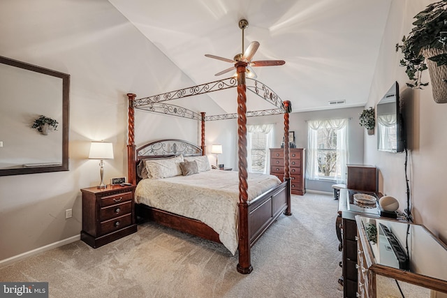 bedroom with a ceiling fan, visible vents, baseboards, vaulted ceiling, and carpet flooring