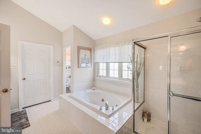 full bath featuring tile patterned flooring, vaulted ceiling, a tub with jets, and a stall shower