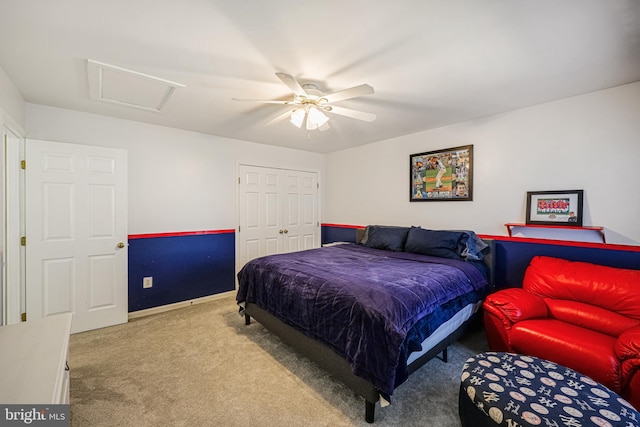 carpeted bedroom with attic access, baseboards, a closet, and ceiling fan