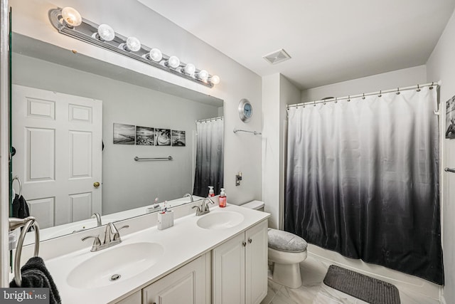 full bath with a sink, visible vents, toilet, and double vanity