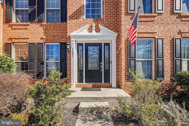 entrance to property with brick siding