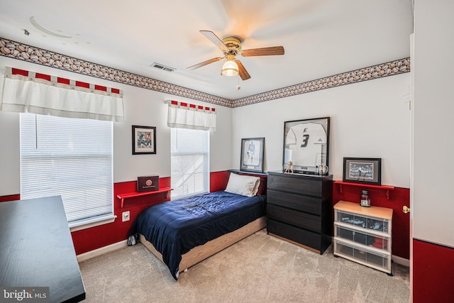 carpeted bedroom featuring baseboards, visible vents, and ceiling fan