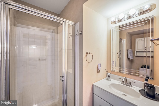 bathroom featuring vanity and a shower stall