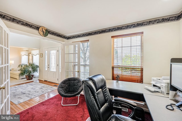 office featuring french doors, wood-type flooring, and crown molding