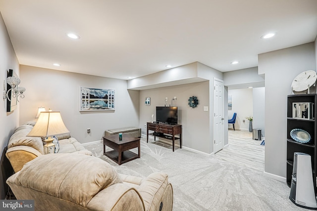 living area featuring recessed lighting, baseboards, and light colored carpet