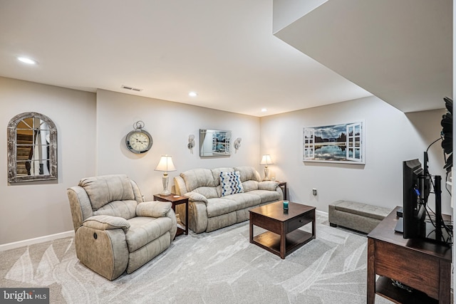 living area featuring recessed lighting, baseboards, and light colored carpet