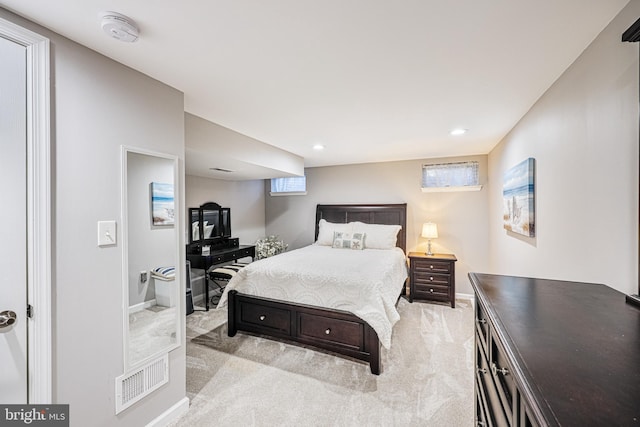 bedroom featuring baseboards, multiple windows, light colored carpet, and visible vents