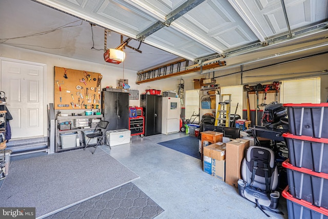 garage featuring a workshop area and a garage door opener